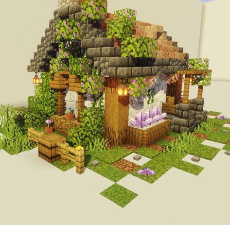 A small house in minecraft. The roof is made of copper steps, and there is a garden with flowers around Garden Area Minecraft, Mossy Cobblestone Minecraft, Minecraft Flower Garden Design, Minecraft Copper Roof, Copper House Minecraft, Minecraft Copper House, Copper Minecraft Builds, Flower House Minecraft, Minecraft Building Ideas Step By Step