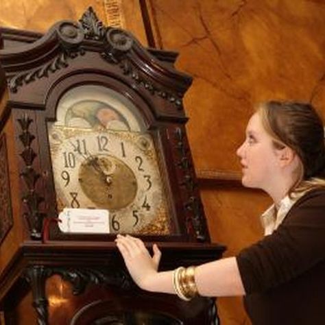 Woman admiring a grandfather clock Antique Clocks Vintage, Grandmother And Granddaughter, Grandmother Clock, Antique Grandfather Clock, Post Modern Architecture, Antique Wall Clocks, Dwelling On The Past, Language Works, Pendulum Clock