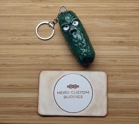 Meet the Not So Positive Pickle, a quirky and comically grumpy addition to your keychain collection! Handcrafted from high-quality polymer clay, this keychain features a sour-faced pickle that's sure to bring a smile (or a smirk) to your face.#keyring #keychains #positivity #supportsmallbusiness #clayart #pickle #grumpypickle #grumpy Pickle Keychain, Steampunk Robots, Lanyard Bracelet, Keychain Collection, Clay Keychain, Poly Clay, Beaded Lanyards, Paracord Bracelets, Beaded Keychains