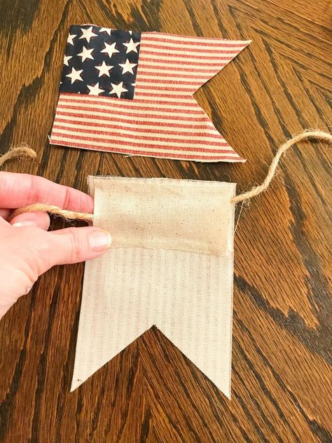 Sometimes you just need to have a picnic on the back patio and sometimes that picnic needs a theme! Actually this little set up was a tour I was part of on Instagram. You can take the tour HERE.I'm going to show you how to make a little patriotic garland. Its really simple and no sewing! You should have time to whip one up before the 4th! You will need the following to recreate my garland:Red and white striped fabricSmall star fabricLight weight muslin fabricScissorsJute twineHot glue… Patriotic Garland Diy, Flag Grommet Crafts, Fourth Of July Diy Decor, Patriotic Bunting Porch, Flag Garland Diy Fabric, Fabric American Flag, American Flag Bunting, Fouth Of July Crafts, Patriotic Crafts Diy