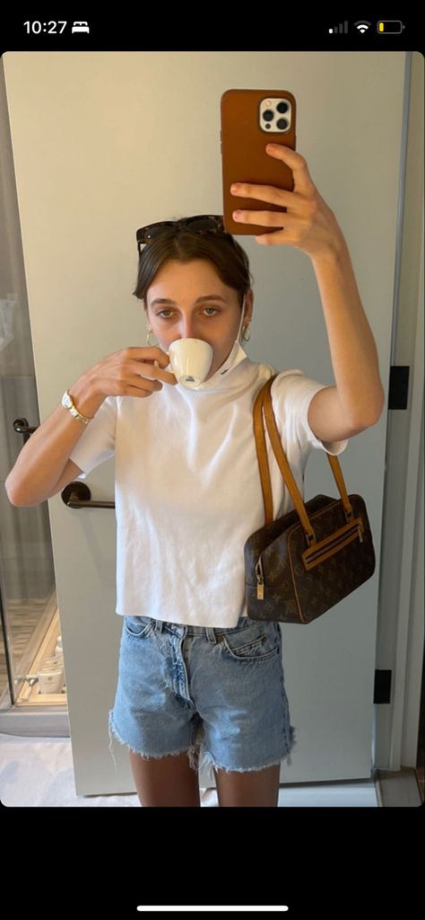 emma chamberlain, girl holding orange phone case drinking a cup of tea, wearing sunglasses, white tee/T-shirt, levis 501 blue denim shorts, and a vintage louis vuitton cite mm bag Vintage Designer Bags, News Highlights, Emma Chamberlain, Vuitton Bag, Longchamp Le Pliage, Vintage Levis, Cloth Bags, Louis Vuitton Bag, Highlights