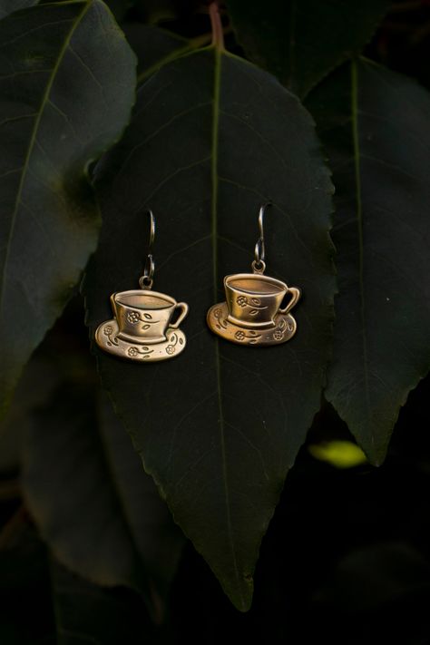 Choose your own tea set earrings! I have these earrings available in 6 different combination options choosing from tea pots, tea cups and a tea bag. See last photo for an example of the tea pot and tea bag earring set with a tea cup pin. This listing is for the tea cup earring set. See my Etsy shop for other combinations. handcrafted from solid (not plated) raw brass tea cups with solid sterling silver ear hooks. A great gift for any tea lover even if that may be you! Each earring weights approx Dark Academia Accessories Earrings, Dark Academia Earrings, Victorian Brass Jewelry With Matching Earrings, Tea Earrings, Green Tea Earrings, Handmade Victorian Brass Earrings, Tea Party Jewelry, Tea Cup Earrings, Tea Cup Jewelry