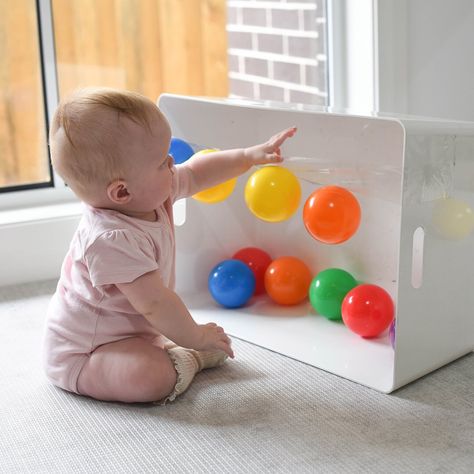 Exploring Sticky! 🖐🏼 Introducing Rory’s new favourite game! A length of sticky tape with balls stuck, for her to pull or smack off! 😋  Rory (6.5 months) is getting so confident with moving & reaching whilst sitting! This little invitation was so easy to set up & kept her busy, swatting balls before I even had a chance to stick them back up!  This would make a great tummy time activity too; allowing your Baby to shift body weight, balance & reach - all skills needed in preparation for crawling Baby Development Activities, Baby Sensory Play, Baby Play Activities, Learning Games For Kids, Busy Boxes, Baby Activities, Baby Learning Activities, Baby Education, Montessori Baby