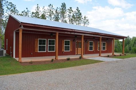 Today’s featured barndominium is found in the beautiful city of Troy, Alabama, and is a stunning example of a rural home with modern amenities and style. Channeling the feeling of a rustic farmhouse with its red vertical siding and low slope roof, this one-story home has all the features that anyone would need while still … Barndominium With Vinyl Siding, Rustic Red Barndominium, Red Barndominium Exterior, Red Barndominium, Single Story Barndominium, One Story Barndominium Floor Plans, Barndo Exterior, Red Barn House, Building A Barndominium