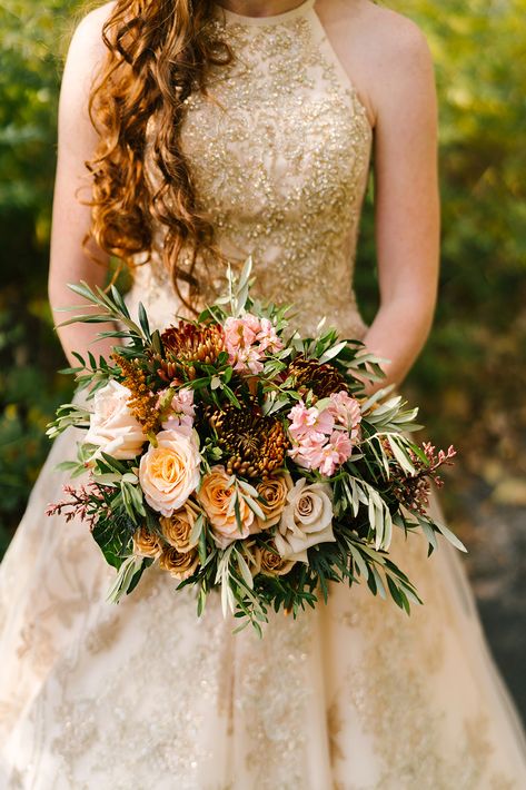 LOVE a bridal gown with gold accents. Beautifully paired with muted fall tones and photographed by Megan Antelek. #wedding #weddingbouquet #bride #bridalbouquet #goldaccents #goldweddinggown #fallwedding #fallflowers Flowers With Gold Dress, Golden Wedding Bouquet, Gold Wedding Flowers, Gold Wedding Gowns, Natural Bouquet, Golden Gown, Gold Bouquet, Copper Dress, Bronze Dress