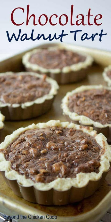 Mini Chocolate Walnut tart made with toasted walnuts and a chocolate filling. This delicious dessert is perfect for any dinner party. #chocolatetart #walnuttart