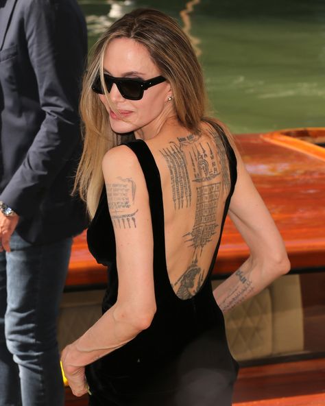 All the Tumblr girlies know exactly what “Quod me nutrit me destruit” means thanks to #AngelinaJolie’s most replicated tattoo, and her collection of body art on full display at #VeniceFilmFestival may inspire a new generation to get inked too. See 30 more celebs whose tatts add edge to glam at the link in bio. Angelina Jolie Back Tattoo, Angelina Jolie Tattoo, Angelina Jolie, Back Tattoo, Back To Black, Film Festival, Cool Girl, Venice, Red Carpet