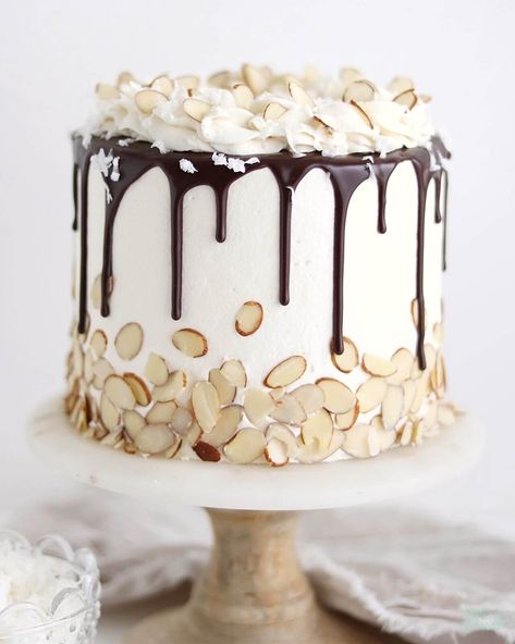 Learn how to make the easiest coconut cake recipe and transform it into Almond Joy Cake with coconut almond buttercream and chocolate ganache Almond Coconut Cake, Almond Joy Cake, Almond Buttercream, Cake With Coconut, Chocolate Ganache Recipe, Milk Chocolate Ganache, Coconut Cake Recipe, Ganache Recipe, Salty Cake