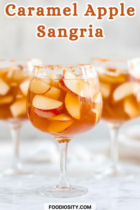 Craving a sweet, refreshing drink for fall? This Caramel Apple Sangria blends crisp apple flavors with a hint of caramel, creating the perfect autumn cocktail for any gathering. Whether you're hosting a party or just want to sip something festive, this sangria is a must-try! Click to get the easy recipe and add a sweet twist to your fall celebrations! Carmel Apple Sangria Easy, Caramel Apple Cider Sangria, Sweet Cocktails Easy, Carmel Vodka, Autumn Sangria, Apple Pie Sangria, Thanksgiving Sangria, Autumn Cocktail, Fall Sangria Recipes