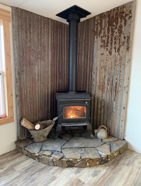 Corner Wood Stove Living Room Layout, Metal Wood Fireplace, Galvanized Metal Wall Behind Wood Stove, Woodstove Backdrop Ideas, Wood Burning Stove Tall Ceiling, Wood Stove Wall Brick, Tiny House Wood Stove Cabin, Wood Stove In Shop, Wood Burn Stove Living Room