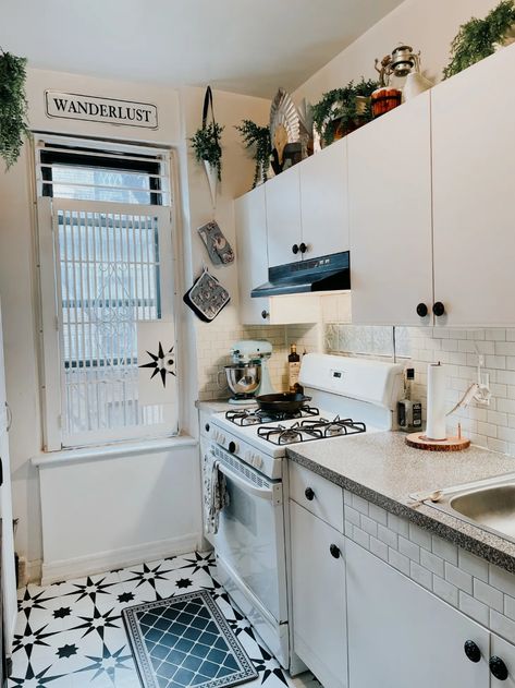 Small NYC Apartment Looks Like a Theater Set and Feels Like a Fairy Tale | Apartment Therapy Small Nyc Apartment, 1980s Kitchen, Blob Mirrors, 80s Kitchen, Antique Writing Desk, White Kitchen Tiles, Home Decor Minimalist, White Tile Floor, White Appliances