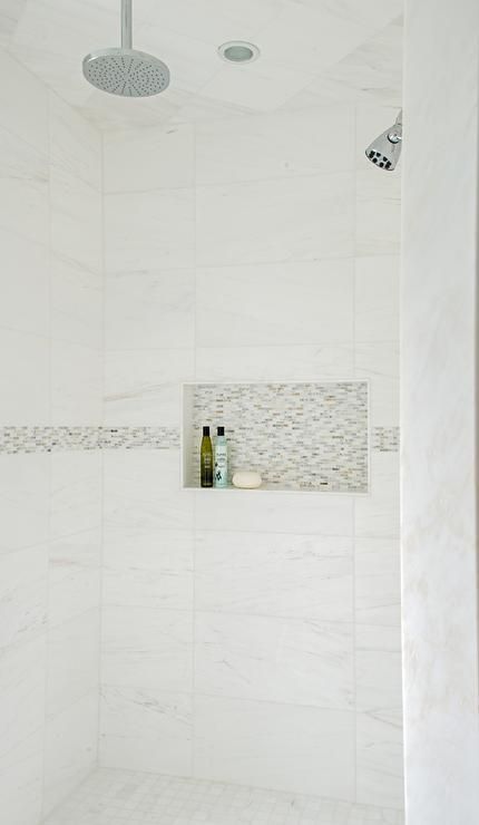 Chic walk-in shower features white marble grid tiles accented with gray mosaic border tiles fitted with a tiled niche as well as two shower heads.: White Marble Shower Tile, Tiled Niche, Two Shower Heads, White Marble Shower, Marble Shower Tile, Mosaic Border, Accent Tiles, Shower Tiles, Marble Showers