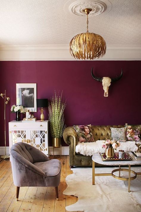 A gorgeous and luxurious interior than uses a moody deep raspberry jewel tone paint colour on the walls but keeping the rest of the interior light and playful. #moodylivingroomjeweltones #moodyinteriordesignlivingrooms #moodylivingrooms #moodyinteriorinspiration Plum Living Rooms, Living Room With Gold Accents, Olive Green Velvet Sofa, Room With Gold Accents, Plum Living Room, Plum Living, Purple Living Room, Furnitur Ruang Keluarga, Olive Green Velvet