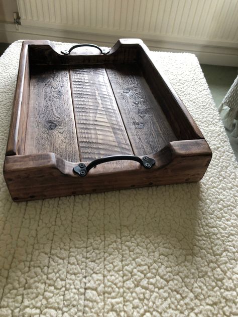 Handmade Farmhouse style rustic serving tray made from reclaimed wood with handles. Perfect for serving breakfast in bed or bringing food and drink to the table. This unique piece also makes a great table centre piece, when dressed with a flower vase or other ornaments it will bring a real feeling of authentic farmhouse to any room.  Dimensions: 21'' long x 15'' Wide x 3'' Deep. Everything we make is done by hand and sustainability is at the core of everything we do. All our products are made from repurposed wood; we love this look as it gives even more character to our already quirky creations. We build products to last, and all wood treatments are animal friendly and non-toxic. We want all of our items to be unique and built just for you, and because we always leave trees alone, personal Rustic Wooden Projects, Rustic Serving Tray, Beginner Wood Working Project, Diy Wooden Tray Ideas, Wooden Trays Diy, Wood Trays Diy, Wood Tray Ideas, Wood Tables Rustic, Wood Tray Diy