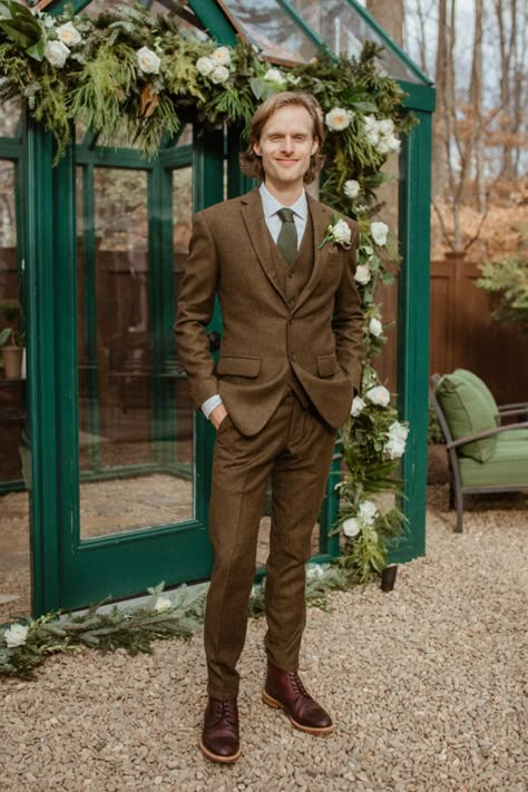 Dark Khaki Suit Wedding, Brown And Green Wedding Suit, Bohemian Wedding Suits For Men, Brown And Green Groomsmen Attire, Cottagecore Wedding Outfit Men, Brown Suit With Green Tie, Forest Groomsmen Attire, Brown And Green Suit, Wedding Suits Groom Brown