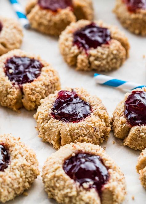 These Thumbprint Cookies are the perfect holiday cookies. Cookie dough balls are coated in walnuts then topped with raspberry jam. An old fashioned cookie but a classic and incredibly delicious! www.jocooks.com #thumbprintcookies Thumbprint Cookies Christmas, Best Thumbprint Cookies, Thumbprint Cookies Easy, Cookies With Jam, Raspberry Thumbprint Cookies, Jam Thumbprint Cookies, Christmas Food Treats, Thumbprint Cookies Recipe, Buttery Shortbread Cookies