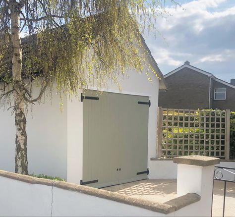 sage green birch aesthetic tree door shed white walls chalkwash mediterranian sun clouds sky mint xanathu Sage Green Windows Exterior Colors, Sage Green And Cream House Exterior, White House With Sage Door, Sage Green Garage, Sage Garage Door, Sage Green Garage Door, Sage Green Front Door White House, Sage Green Shed, Garage Door Colours