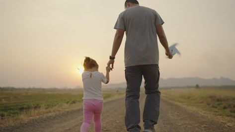 4k Video slow-motion, An Asian father took his daughter's hand for a walk. The right-hand holds a turbine During the sunset Family concept. Walking Together, Father Art, Father And Daughter, Free Stock Video, 4k Video, Free Sign, Father Daughter, Model Release, Photo Template