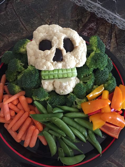 Sculpted califlower into a skull. Used olives for the eyes and nose and celery for the teeth. I used toothpicks to hold it all together. Decorative Veggie Tray, Spooky Halloween Veggie Tray, Halloween Veggie Charcuterie Board, Halloween Vegetable Platter, Halloween Meat Tray, Spooky Veggie Platter, Pumpkin Veggie Tray, Halloween Fruit And Veggie Tray, Halloween Skeleton Veggie Tray