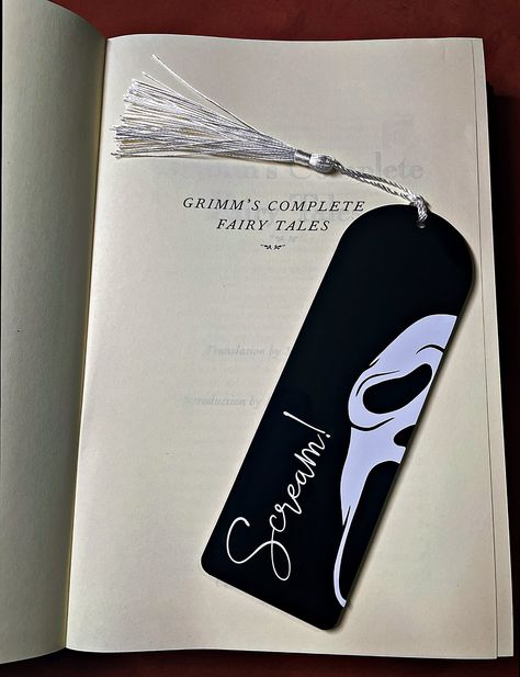 What's your favourite scary book?  Mark your page with this ghost face bookmark, the perfect gift for any horror bookworm. Handmade to order  using high quality, 3mm thick laser cut acrylic layered with permanent vinyl design and a colour co-ordinated tassel.   The design is on one side only, the other side will be left blank.  -----Size-----  15cm length x 5cm width x 3mm depth I'd love to see your photos so please tag us @helheimhomewares on Instagram.   Free delivery included -----Custom colo Science Bookmarks Diy, Book Mark Inspo Aesthetic, Science Bookmark Ideas, Book Mark Drawings, Cool Book Mark Ideas, Scream Bookmark, Bookmark Handmade Ideas, Thriller Bookmarks, Book Marks Design