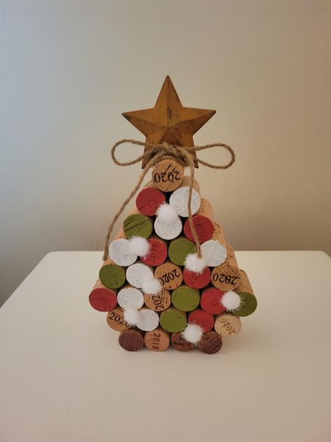 Elevate your holiday decor with my unique handcrafted Christmas trees. Created from recycled wine corks. Each piece is hand- painted  adorned  with snow balls then topped with a metal star &jute bow. Adding a touch of charm and eco-friendliness to your holiday celebrations. Celebrate the season with this charming tree or great to give as a gift. Wine Christmas Decorations, Cork Snowflakes, Crafts With Wine Corks, Oktoberfest Crafts, Wine Cork Christmas Crafts, Cork Upcycle, Cork Decorations, Wine Cork Snowman, Christmas Cork Ornaments