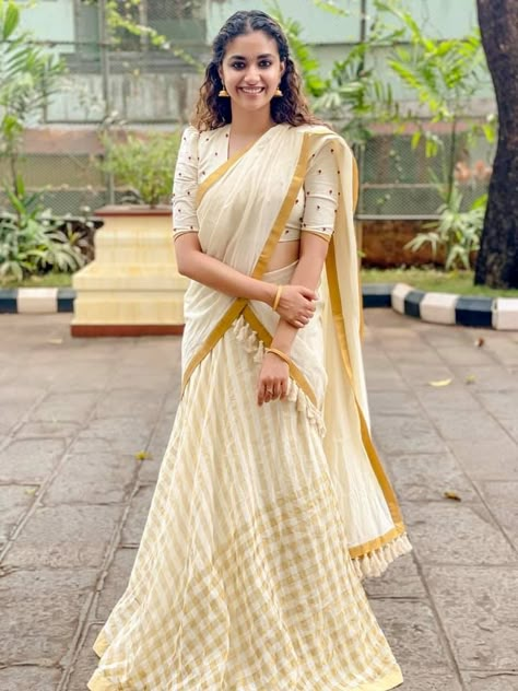 Keerthy Suresh in ivory half saree by poornima indrajith for guruvayur visit 1 Kasavu Half Saree, Onam Outfits Ideas, Onam Dress, Kerala Saree Blouse, Onam Outfits, Kerala Saree Blouse Designs, Onam Saree, Long Skirt And Top, Saree Hairstyles