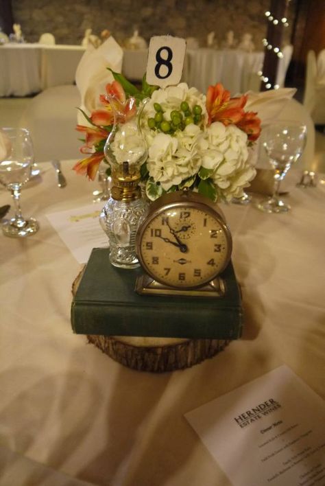 Vintage centrepieces adds visual interest and are great conversation pieces. Book, storm lantern and clock for rent. Clock Centerpieces, Luncheon Decor, Storm Lantern, Vintage Centerpieces, Ladies Luncheon, Lantern Centerpieces, Vintage Rentals, Train Station, Conversation Piece