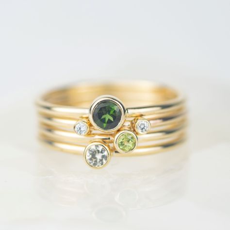 Say hello to Hydrus, our gold stacking ring set featuring gorgeous green gems and sparkling diamonds set in solid recycled 9ct gold. Two tiny diamonds sit on one band slightly apart, designed to sit beautifully on either side of the green tourmaline, peridot and white sapphire rings. Our Andromeda stacking ring sets are named after constellations - Hydrus being the water snake. The rings are designed to be worn together and apart, creating a beautifully varied set. Material - Made from recycled Rings With Multiple Stones, Peridot And Emerald Ring, White Sapphire Rings, Gold Jewellery Set, Multi Gem Ring, 5 Stone Ring, Pinkie Ring, Diamond Wrap Ring, Water Snake