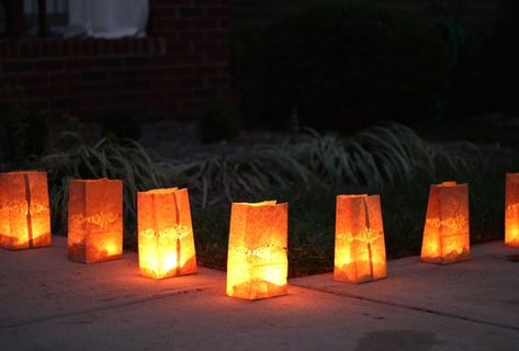 How to Create Safe Paper Bag Luminaries | eHow Halloween Paper Luminaries, Luminary Bags Diy, Paper Bag Candles, Luminaries Paper Bag, Paper Bag Luminaries, Paper Bag Lanterns, Luminary Diy, Halloween Paper Bags, Garden Exterior