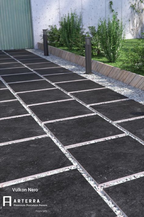 Part of our Arterra collection, Vulkon Nero pavers carries dark and dreamy to the outdoors. Featuring deep charcoal tones in a matte finish, use the pavers on a pathway into the indoors to create a true indoor/outdoor lifestyle. Black Pavers Walkways, Black Concrete Walkway, Dark Pavers Patio, Charcoal Pavers Patio, Pavers With Black Rocks In Between, Walk Pad, Gray Paver Walkway, Driveway Update, Dark Pavers Around Pool