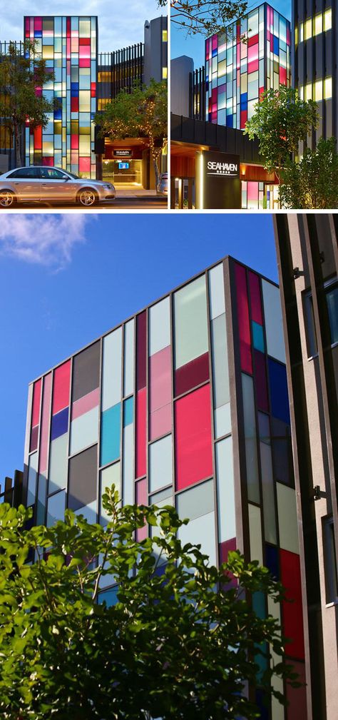 The front facade of this resort is covered in colored rectangular windows that add a pop of color to the street. Colored Facade Architecture, Colorful Facade Architecture, Glass Facade Design, Colorful Facade, Simple Architecture, Glass Facade, Front Facade, Colorful Buildings, Colour Architecture