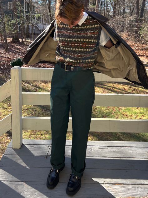 masculine person wearing a sweater vest and dark green dickies pants and black loafers Masculine Vintage Outfit, Masculine Sweater Outfit, Academia Outfits Masculine, Queer Preppy Style, Goblin Core Fashion Men, Fem Masculine Outfits Men, Cottagecore Outfits Masculine, Cottage Core Outfits Masc, Soft Academia Aesthetic Outfits Men