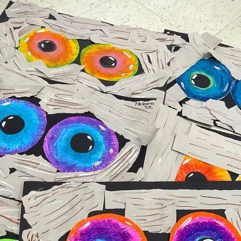 Ashley H on Instagram: "Analogous Mummy Eyes 👀 2nd graders lived this one. Oil pastel eyes, collaged grey paper strips on top! 2 day project! They look great hanging over their lockers! Collaboration with my team teacher @art_with_mrs.kay #artprojectsforkids #elementaryart" Eyes Craft, Teacher Art, Grey Paper, Halloween Paper Crafts, October Crafts, Halloween Mummy, Craft Club, Halloween Paper, My Team