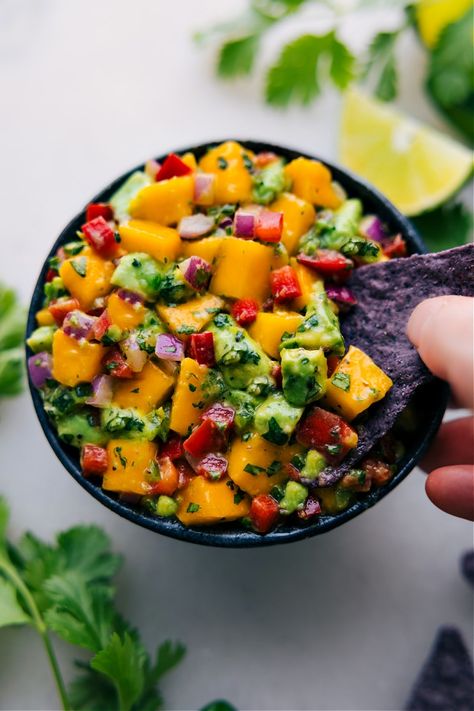 Our Mango Salsa is the recipe we reach for when mangoes are at their peak of ripeness! It's an effortless blend that's brimming with flavor Snack Quick, Chelsea's Messy Apron, Mango Avocado Salsa, Cilantro Lime Chicken, Avocado Salsa, Summer Dishes, Chips Recipe, Mango Salsa, Lime Chicken