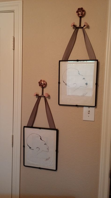 neat way to use hooks and ribbon to hang pictures. Hanging Pictures With Ribbon, Ribbon Hanging Picture Frames, Picture Frame Curtain Rod Hanging Photos, Chain Picture Hanging, Chain Hanging Picture Frame, Hanging Pictures On The Wall, Victorian Pictures, Decorative Wall Hooks, Hanging Picture Frames