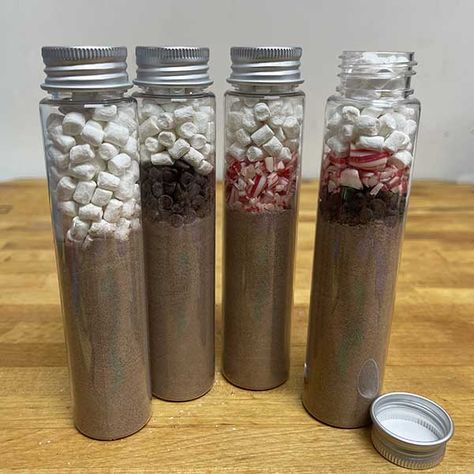 Hot Chocolate Tubes: Create Super Cute Gifts - My Growing Creative Life Hot Cocoa In Test Tube, Hot Chocolate Tubes Gift Ideas, Test Tube Hot Chocolate Diy, Hot Chocolate Tubes, Cheap Christmas Gift Ideas For Coworkers Easy Diy, Hot Cocoa Spoons, Diy Hot Chocolate Gifts, Hot Chocolate Gift Ideas, Holiday Mason Jar Crafts