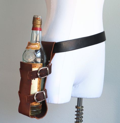 Everyone wishes they could carry their bottle full of choice delicious drink, be it alcoholic or not, but often don't want the arduous task of carrying it in their hands. You need not have this worry anymore! Holster your tasty beverage at your side and be ready for a quick draw quaffing at anytime. This cowhide leather holster is adjustable and will fit many different sizes of bottles and comes in a few color choices. Adjusts with two buckles Simply slides onto a belt Book Holster, Knife Holster, Front Pocket Wallet, Quick Draw, Ex Machina, Pocket Wallet, Fantasy Clothing, Character Outfits, Costume Design