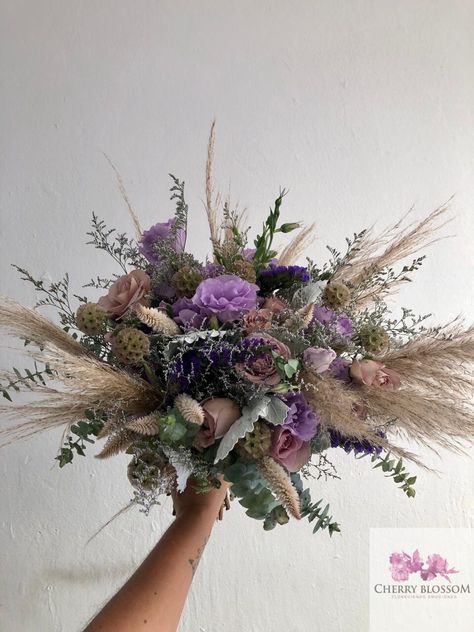 CBR680 Weddings at the beach , soft romantic bridal bouquet with pampas grass lilas and purple Flowers at Tulum Riviera Maya and Playa del Carmen Mexico by Cherry Blossom  #bridalbouquet #pampasgrassbouquet Purple Pampas Grass Bouquet, Lavender Boho Wedding Decor, Purple And Pampas Grass Wedding, Boho Purple Bouquet, Lavender And Pampas Wedding, Pampas Grass And Lavender Wedding, Boho Wedding Bouquet Purple, Purple Wild Flower Bouquet, Purple Boho Wedding Decor