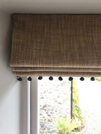 On the bottom edge of blinds, I like to add a trim with a bobble or a tassel as it helps to soften the blunt edge of a blind as well as making it a little fun and playful. Dress Up Blinds, Roman Blind Trim Ideas, Roman Blinds With Trim, Roman Blinds With Borders, Roman Blinds Border, Roman Blinds With Pom Poms, Roman Blinds With Tassels, Roman Blinds With Contrast Border, Natural Blinds