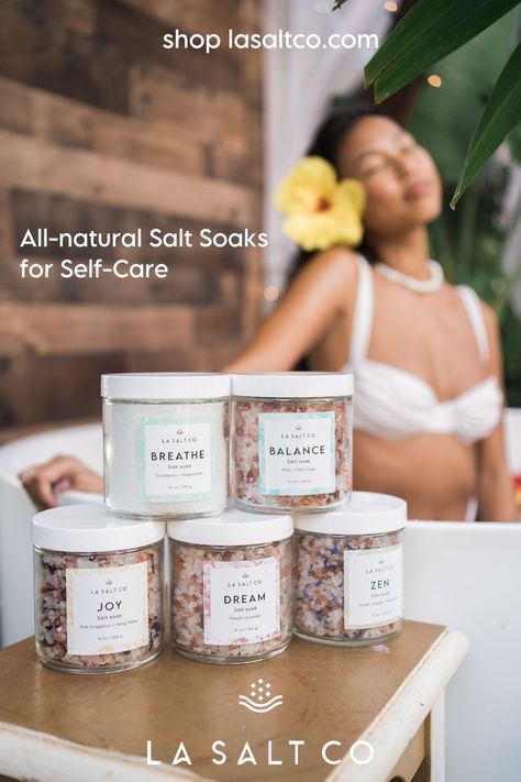 A tan Pacific Islander girl relaxing in a tub. She is wearing a white bikini and yellow hibiscus flower in her hair. In front of her is a table with all 5 of LA SALT CO's signature salt soaks, including Breathe, Balance, Dream, Joy and Zen. Sunday Rest, Bath Salts Recipe, Skincare Products Photography, Facial Steaming, Perfume Photography, Single Humor, Clean Candle, Body Care Products, Bath Essentials