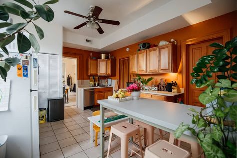 Rust painted kitchen with wooden cabinets. Dated Kitchen Cabinets, Dated Kitchen, Hickory Kitchen Cabinets, Parisian Bedroom, Hickory Cabinets, Apartment Painting, Cabinets Makeover, Roof Tops, Chicago Apartment