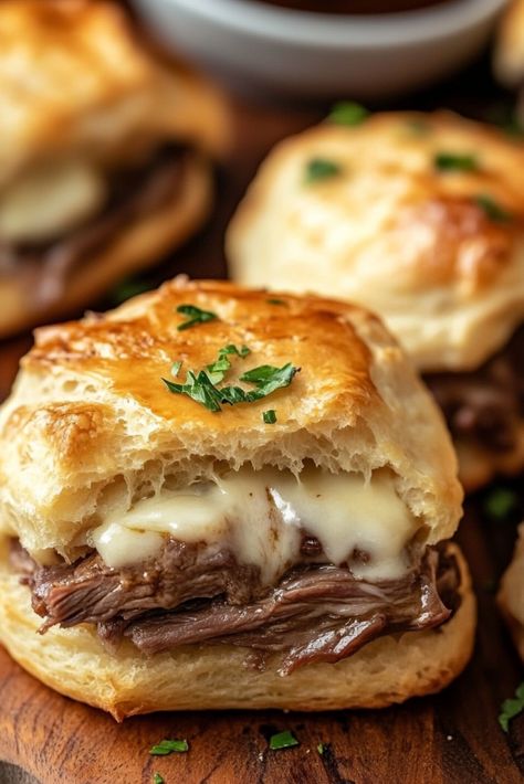 French Dip Biscuits Recipe – These flaky refrigerated biscuits are filled with tender roast beef, melted provolone, and a kick of horseradish, then baked to perfection. When they come out of the oven, brush them with melted butter for an extra layer of flavor. Serve with hot au jus on the side for dipping—absolutely delicious! Roast Beef Sammies, French Dip Biscuits Recipe, French Dip Biscuits, Biscuit Sandwiches Ideas, Stuff Biscuits, Roast Beef Horseradish Sauce, Crab Rangoon Egg Rolls, Amaretto Recipe, Creamy Beef And Shells