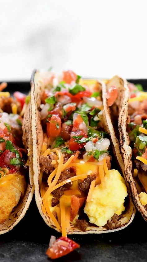 Imagine starting your day with breakfast tacos so delicious, you'll wonder why they're not on the Taco Bell menu. Packed with fluffy scrambled eggs, crispy tater tots, creamy cheese sauce, and savory bacon, these tacos are a morning game-changer. Perfect for feeding a crowd, this recipe allows you to prepare the ingredients in advance and set up a fun, buffet-style taco bar where everyone can create their own tasty masterpiece. Breakfast Menu Ideas, Taco Bell Menu, Breakfast Tacos Recipe, All Day Breakfast, Fluffy Scrambled Eggs, Tiffin Recipe, Breakfast Sandwich Recipes, Mexican Breakfast Recipes, Breakfast Burger