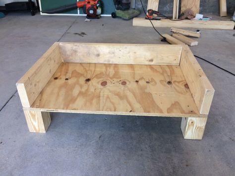 DIY dog bed. Made from 4x4 post wood, plywood, and 2x6s. Going to sand the corners and paint it all gray, then make a cushion and pray my a-hole dog doesn't chew it up! Outdoor Dog House Ideas, Dog House Ideas, Dog Bed Frame, Wood Dog Bed, Raised Dog Beds, Wooden Dog Bed, Pallet Dog Beds, Dog Bedroom, Diy Pet Bed