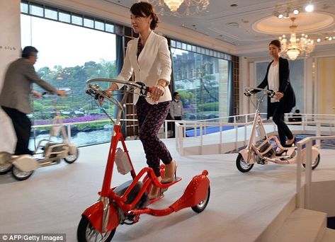 The standing-style Walking Bicycle, pictured here being tested by Japanese journalists, features an electric motor capable of speeds of up to 15mph (24km/h). It comes in silver, pictured left, red, pictured centre, and pink, pictured right and goes on sale in July for $3,000 (£1,780) Motorized Trike, Walking Bicycle, Home Security Camera Systems, Home Security Camera, 3dprinting Design, Cross Trainer, Security Camera System, Cool Bicycles, Security Cameras For Home