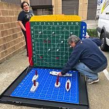 Giant Battleship Game - Event Party Rental Video Amusement California Giant Battleship Game, Battleship Float Ideas, Giant Battleship Game Diy, Battleship Game Decorations, Lifesize Board Games, Board Game Parade Float Ideas, Board Game Float Ideas, Battleships Game, Wedding Barrels