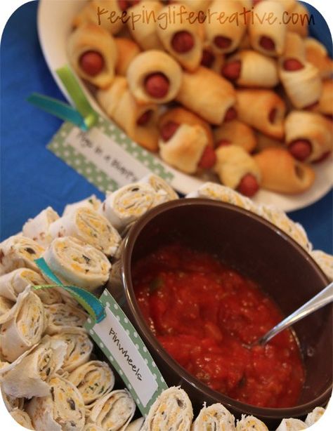 You may remember I was planning a carnival-themed birthday party for my three kiddos. I had lots of requests to post pictures, so here are a few details all about the carnival-themed party food. The Menu Mini Pigs in a Blanket  BBQ Beef sliders Hot Spinach and Artichoke Dip with Chips Veggies and dip Pinwheels Caramel Apples drizzled with chocolate (take home gift) Red Velvet and Cream Cheese Cake Balls dipped in Carnival Theme Appetizers, Circus Food Ideas, Circus Party Foods, Carnival Party Foods, Carnival Foods, Homemade Wraps, Party Food Menu, Circus Food, Carnival Birthday Party Theme