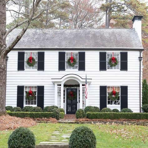 Christmas Wreaths On Windows, Wreaths On Windows, White Colonial House, Southern Home Magazine, Christmas Wreaths For Windows, Colonial Revival House, White Colonial, Colonial House Exteriors, Black Shutters