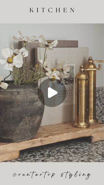 Evelyn Hernandez on Instagram: "Kitchen Counter Styling ✨  My kitchen is currently a space I am not fully in love with but that will not stop me from making it beautiful with some decor! Since my countertops are so busy, its very hard for anything to stand out on its own. Trivets and trays are my best friend when it comes to styling this space and this wooden trivet from @luxebco is absolutely perfect. Definitely elevated everything placed on top of it.   Stay tuned for how I styled the rest of my kitchen in this weeks Youtube video 🤍   Comment “Links” to shop this post!   #kitchenstyling #kitchencounterstyling #kitchendesign #kitchenhomedecor #kitchendecor #granitecountertops #granitecounterstyling #woodentrivets #woodenrisers #wooddecor #vintagedecor #rusticdecor #stylewithme #whatiboug How To Style Kitchen Countertops, Kitchen Styling Countertops, How To Decorate Kitchen Counters, Counter Styling, Kitchen Counter Styling, Kitchen Island Centerpiece, Kitchen Countertop Decor, 2024 Kitchen, Instagram Kitchen