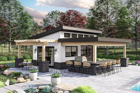 This backyard space has a sleek exterior with board and batten siding and thinset stone.  An outdoor kitchen, with a built-in grill, paired with a pergola covered patio make this plan the perfect space to relax and host get togethers.  A small wet bar with a full refrigerator sits on the inside of the pool house along with plenty of space for hanging out. Pool Poolhouse Sauna, Modern Guest House With Outdoor Fireplace, Pool Poolhouse Sauna Outdoor, Backyard New Build, Pool House With Storage Plans, Pool House With Wall Cabinet For Extra Storage, Roll Up Door Pool House, Pool House With Outdoor Kitchen, Small Wet Bar